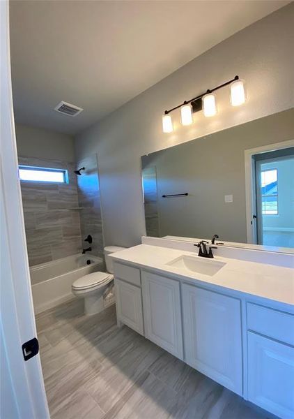 Bath 2 downstairs with window for natural light, quartz counters & 12x24 tile Bath 2 downstairs with window for natural light, quartz counters & 12x24 tile