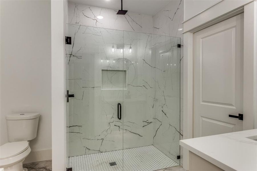 Bathroom with a marble finish shower and vanity Bathroom with a marble finish shower and vanity