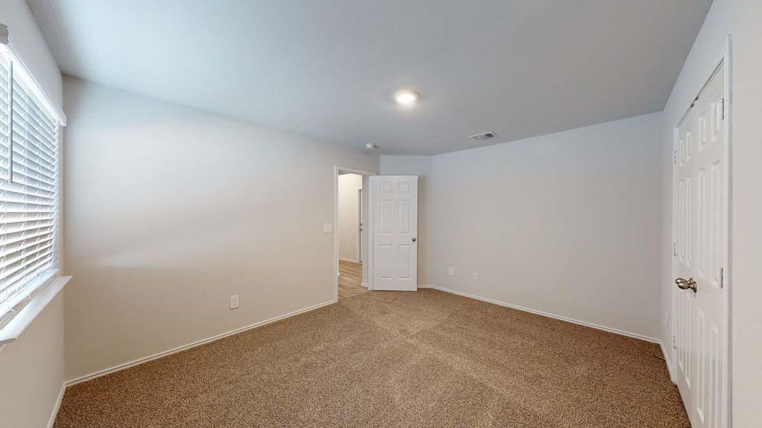 Unfurnished bedroom with a closet and carpet