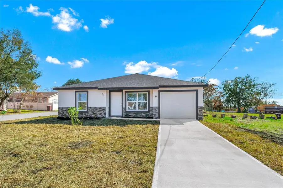 Front exterior of a new home in , Haines City, FL, highlighting curb appeal (Image 1). Front exterior of a new home in , Haines City, FL, highlighting curb appeal (Image 1).