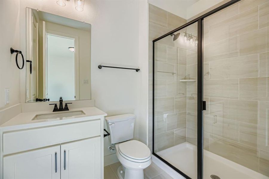 Full bathroom featuring a stall shower and vanity Full bathroom featuring a stall shower and vanity