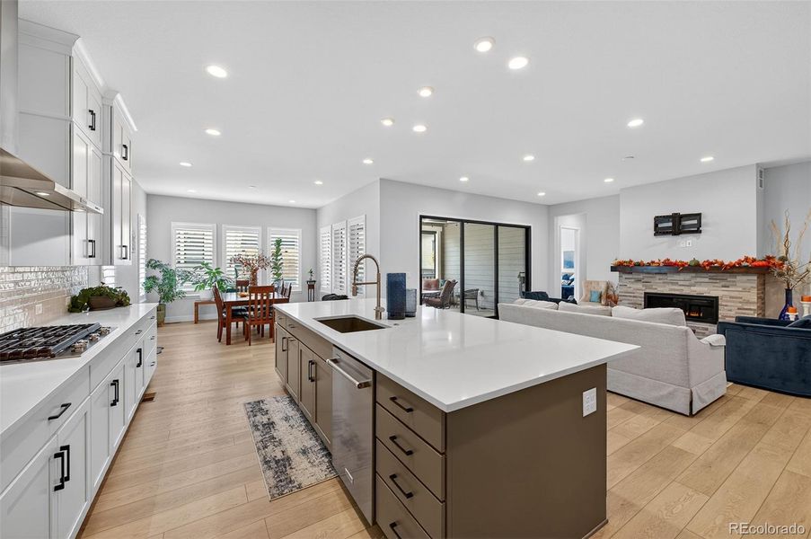 Kitchen to Dining View – Open layout connects the kitchen, dining area, and living room, with abundant natural light and views to the covered patio.