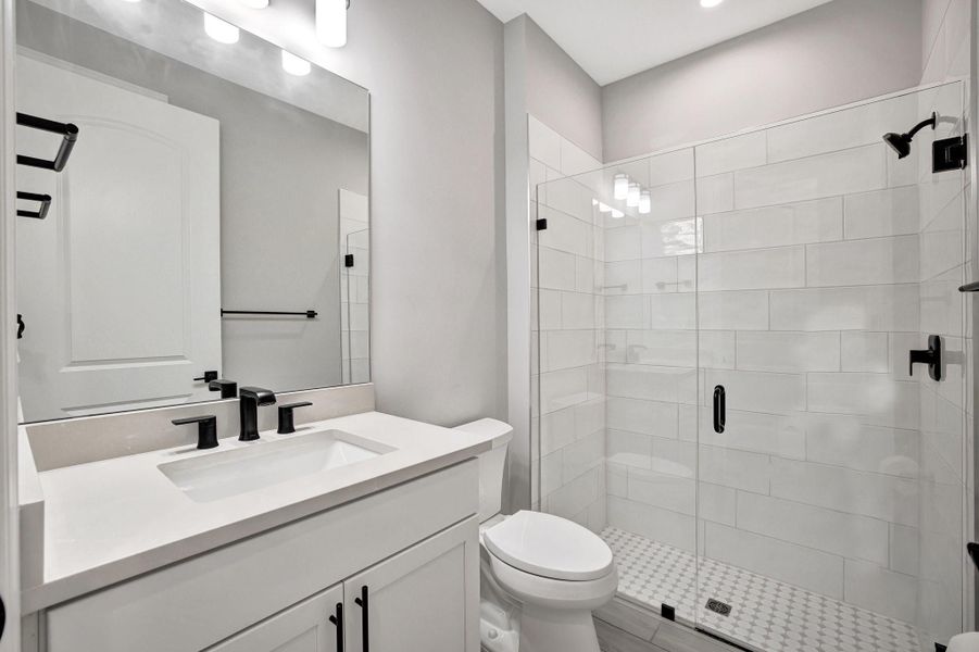 Bedroom 2 bathroom with linen and walk-in shower