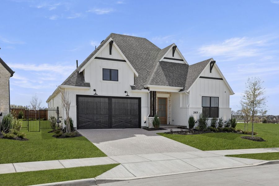Front exterior of a new home in Mustang Lakes, Celina, TX, highlighting curb appeal (Image 2). Front exterior of a new home in Mustang Lakes, Celina, TX, highlighting curb appeal (Image 2).