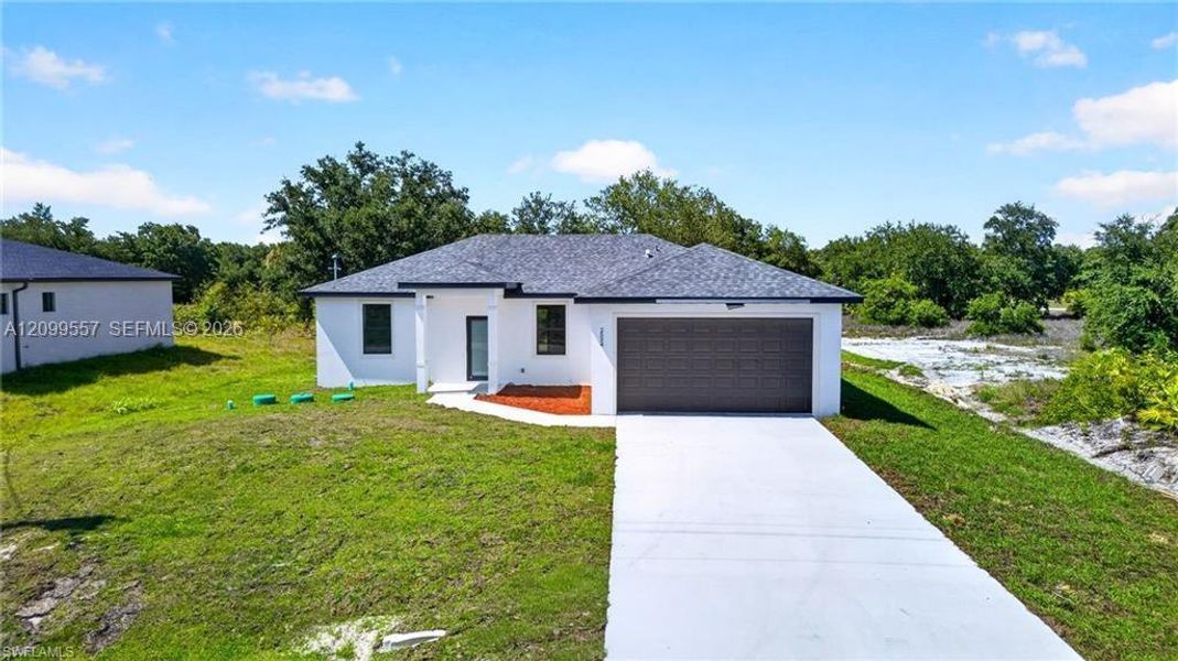 Front exterior of a new home in , Lehigh Acres, FL, highlighting curb appeal (Image 2). Front exterior of a new home in , Lehigh Acres, FL, highlighting curb appeal (Image 2).