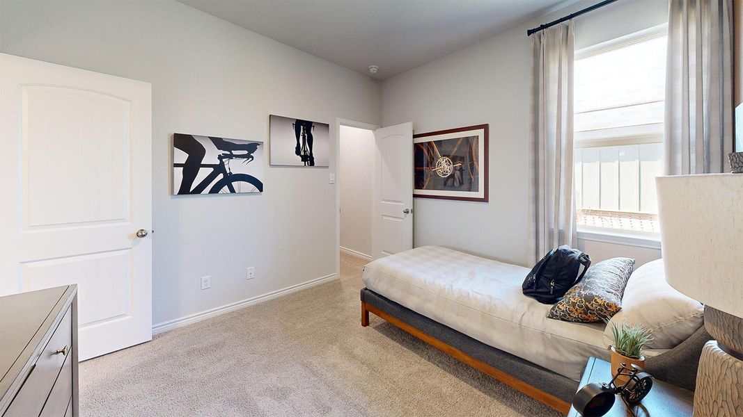 Bedroom featuring light carpet and baseboards Bedroom featuring light carpet and baseboards