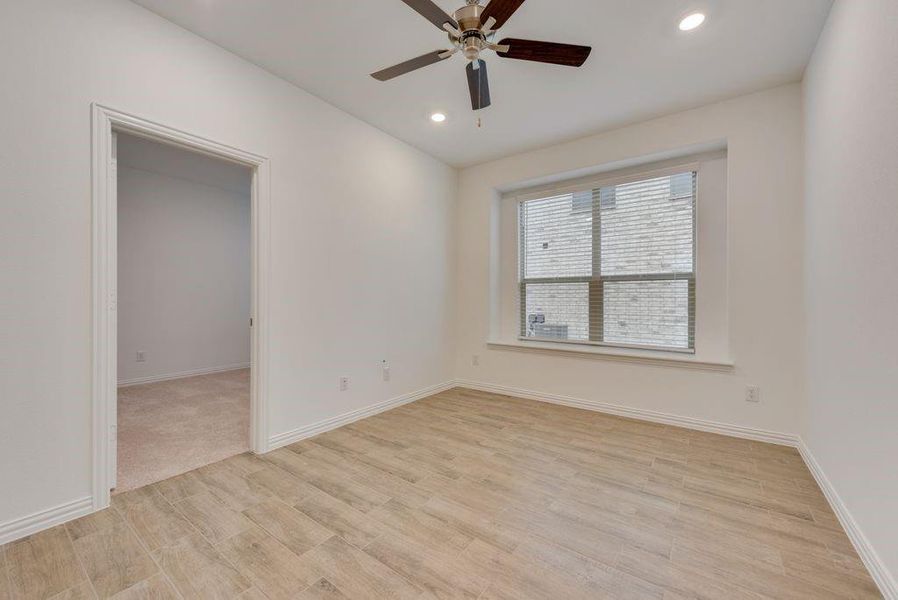 Carpeted empty room with ceiling fan