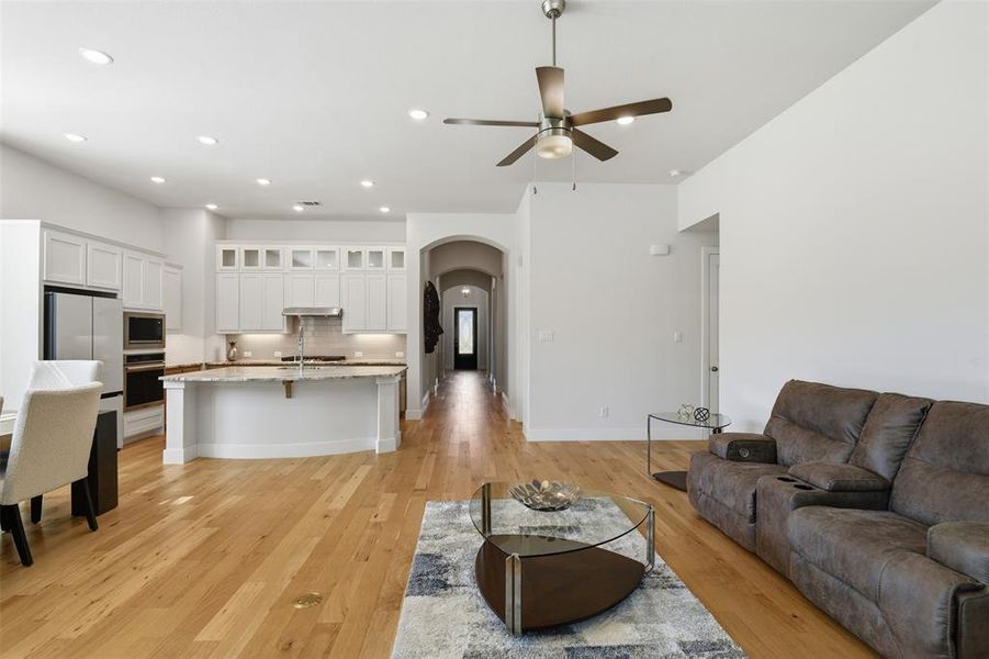 Open-concept living area with wood-finish flooring Open-concept living area with wood-finish flooring