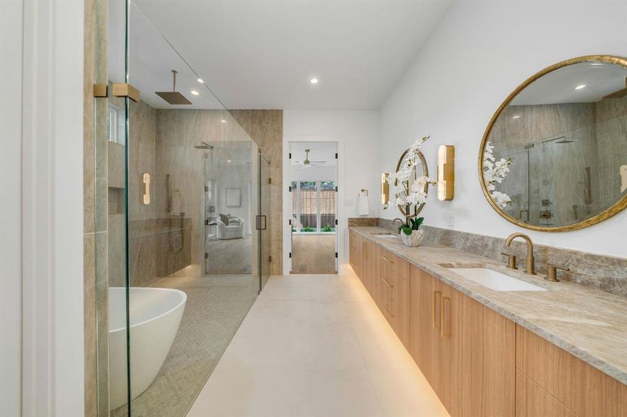Full bathroom featuring double vanity, a freestanding bath, a shower stall, a ceiling fan, and recessed lighting Full bathroom featuring double vanity, a freestanding bath, a shower stall, a ceiling fan, and recessed lighting