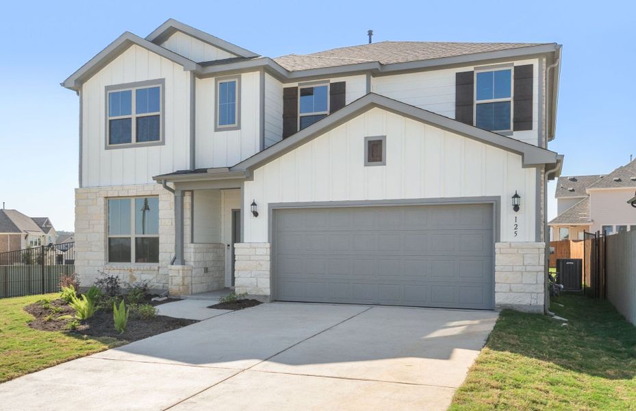 Front exterior of a new home in Saddleback at Santa Rita Ranch, Liberty Hill, TX, highlighting curb appeal (Image 25). Front exterior of a new home in Saddleback at Santa Rita Ranch, Liberty Hill, TX, highlighting curb appeal (Image 25).