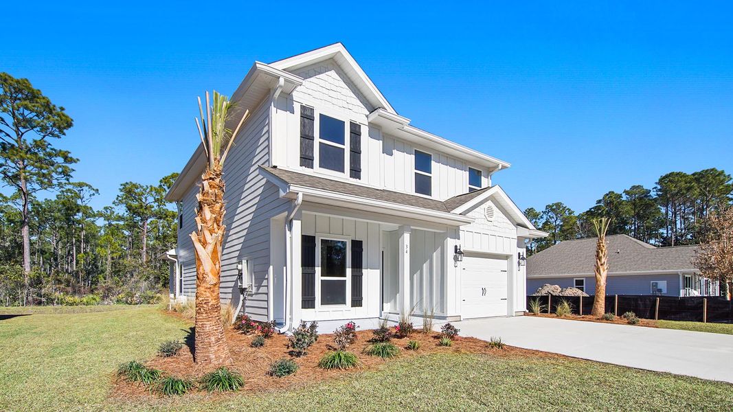 Front exterior of a new home in WindMark Beach, Port Saint Joe, FL, highlighting curb appeal (Image 22).
