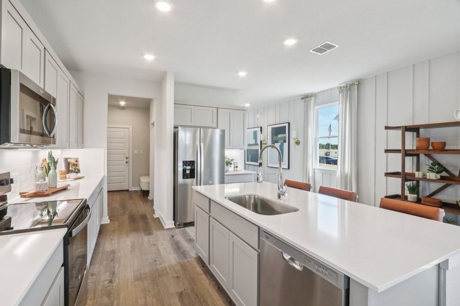 A kitchen with white cabinets. A kitchen with white cabinets.