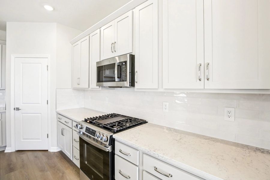 Gas stove and plenty of cabinets and drawers throughout
