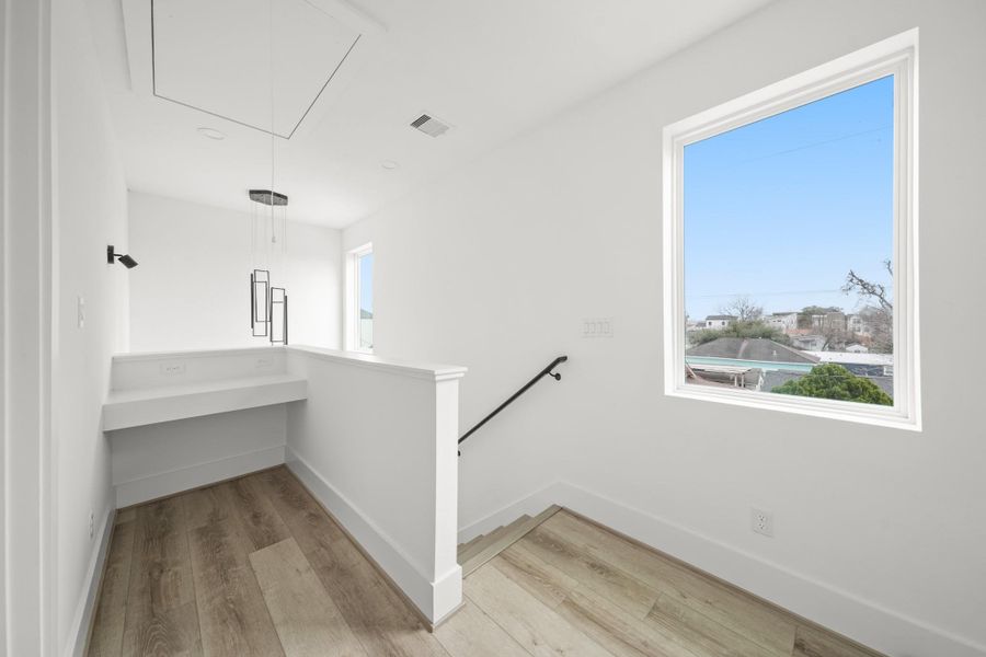 Ideally situated at the top of the stairwell, this dedicated study nook features a built-in desk and overhead lighting. Ideally situated at the top of the stairwell, this dedicated study nook features a built-in desk and overhead lighting.