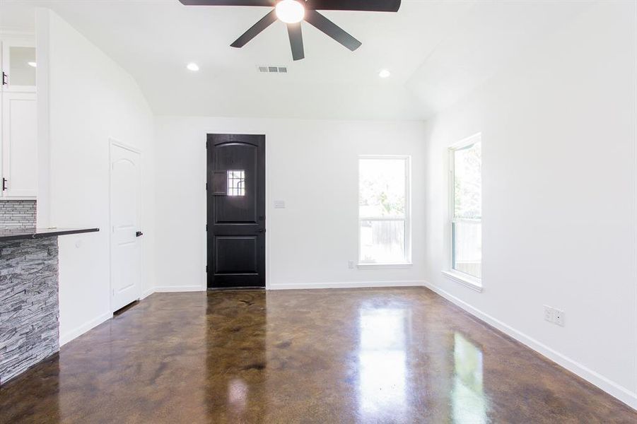 Foyer featuring ceiling fan and lofted ceiling