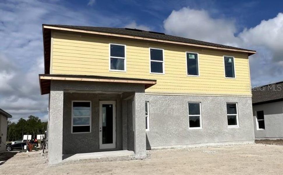 Front exterior of a new home in Hawks Run, Kissimmee, FL, highlighting curb appeal (Image 7).