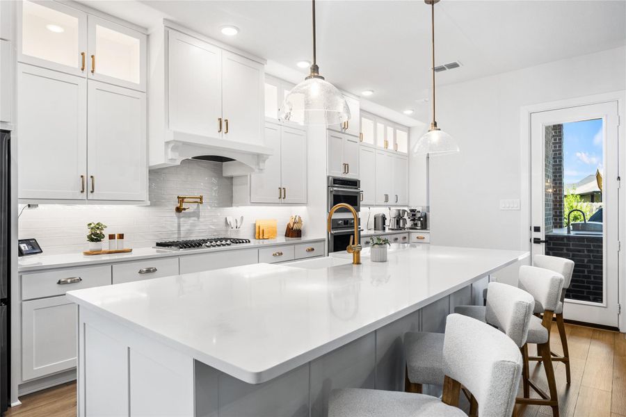 Beautifully appointed kitchen with ceiling-height cabinetry, refined gold hardware, and a timeless, elevated design