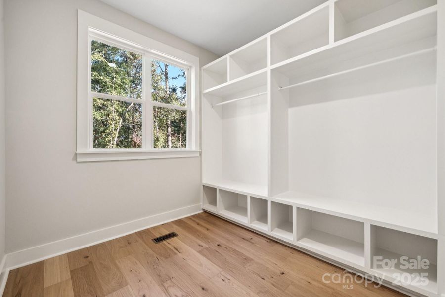 Primary Bedroom's walk-in closet with built in shelving Primary Bedroom's walk-in closet with built in shelving