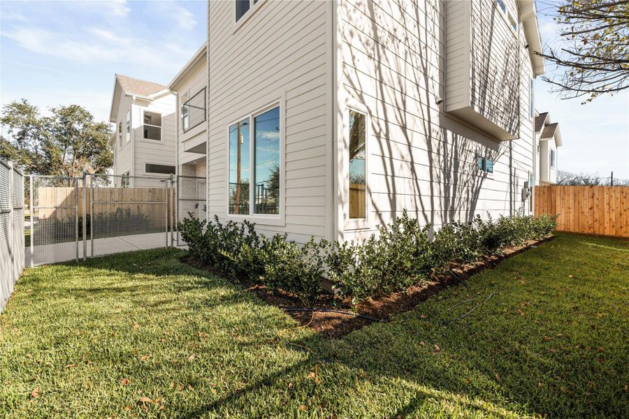 Thoughtfully landscaped grounds wrap the entire home, creating a sense of separation and outdoor space that feels both private and intentional.