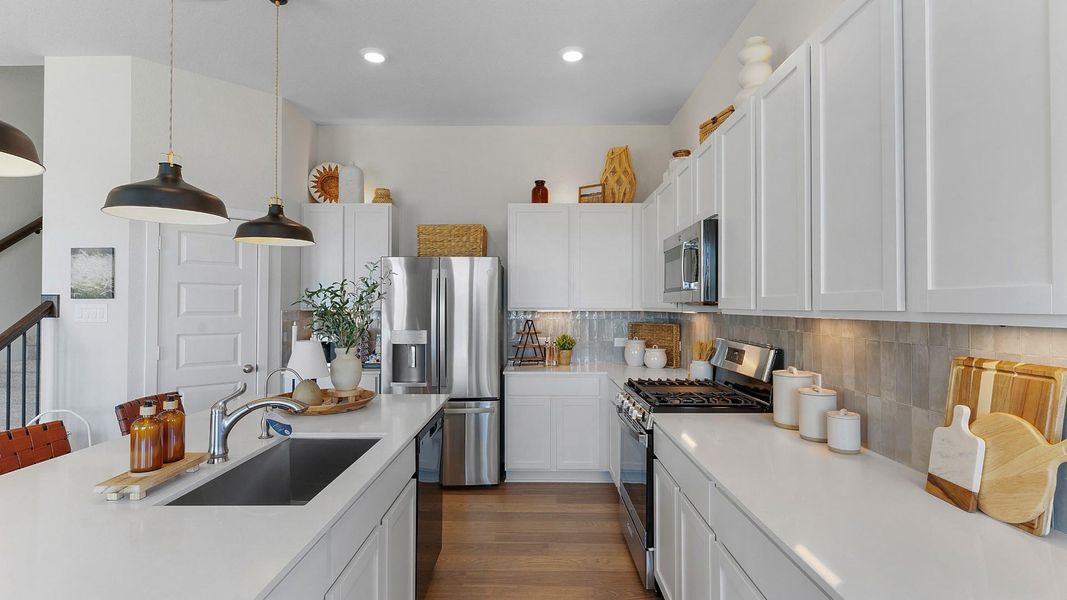 Culinary adventures await in this naturally illuminated kitchen, boasting a spacious island and top-tier stainless steel appliances. Culinary adventures await in this naturally illuminated kitchen, boasting a spacious island and top-tier stainless steel appliances.