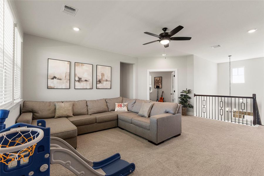 A versatile bonus room offers ample space for recreation and relaxation, complemented by recessed lighting and a stylish ceiling fan. A versatile bonus room offers ample space for recreation and relaxation, complemented by recessed lighting and a stylish ceiling fan.