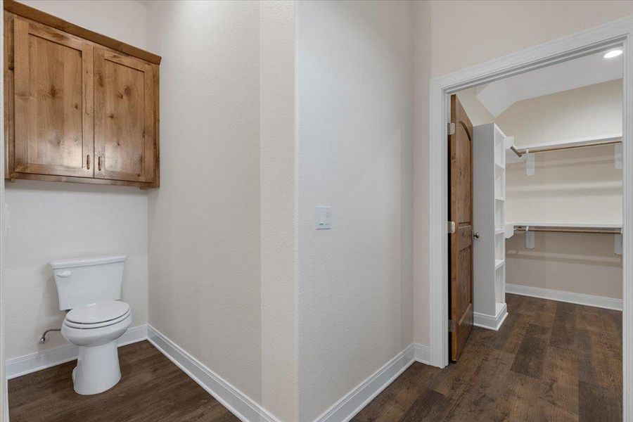 Bathroom featuring toilet and wood finished floors