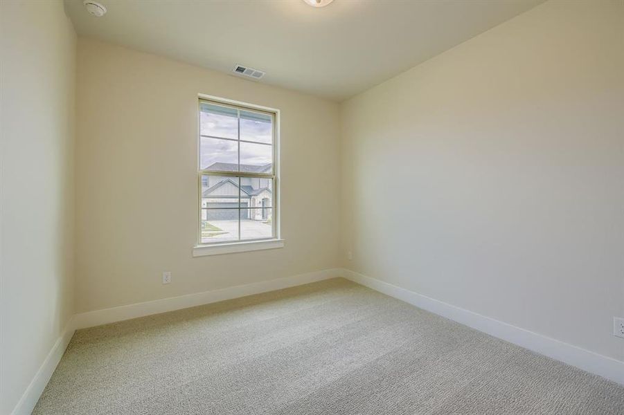 Empty room with carpet floors and baseboards Empty room with carpet floors and baseboards