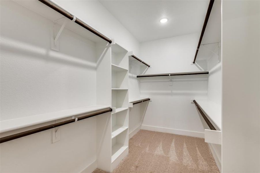Walk in closet featuring light colored carpet Walk in closet featuring light colored carpet