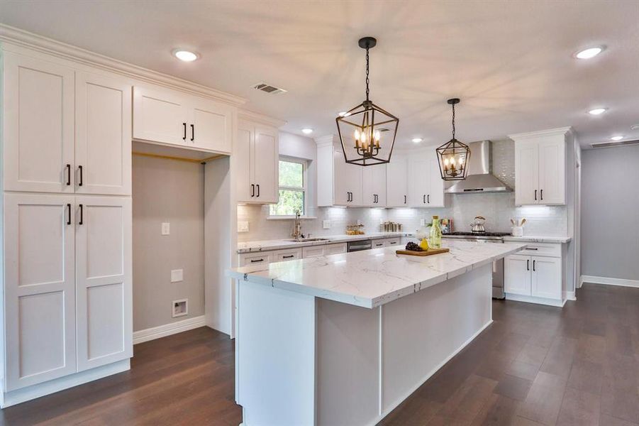 Architecturally Designed With Style! Solid wood cabinetry with Dovetail drawer construction. Antique bronze hardware and pendent light fixtures.