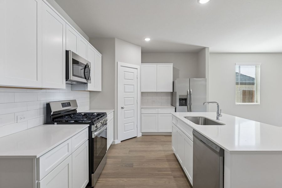 Kitchen in the Holden home plan by Trophy Signature Homes – REPRESENTATIVE PHOTO Kitchen in the Holden home plan by Trophy Signature Homes – REPRESENTATIVE PHOTO