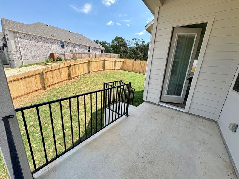 Fenced backyard with a patio area Fenced backyard with a patio area