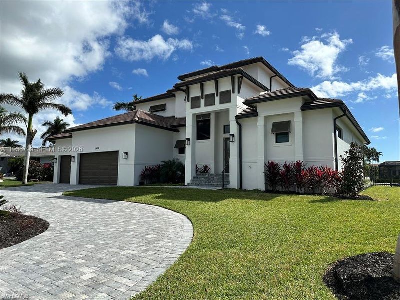 Front exterior of a new home in , Marco Island, FL, highlighting curb appeal (Image 4).