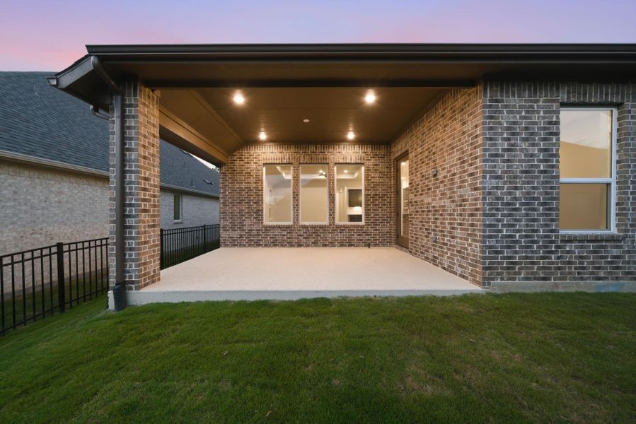 Covered patio overlooking a private backyard—perfect for relaxing or entertaining at sunset.