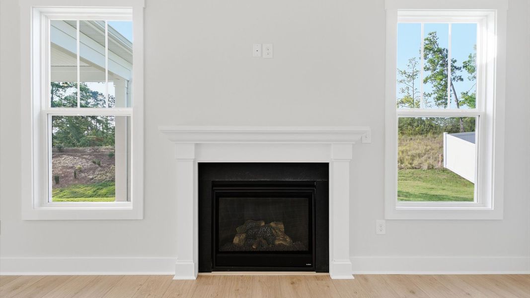Superior design shines in this open-concept family room with an electric fireplace, timeless finishes, and a modern edge