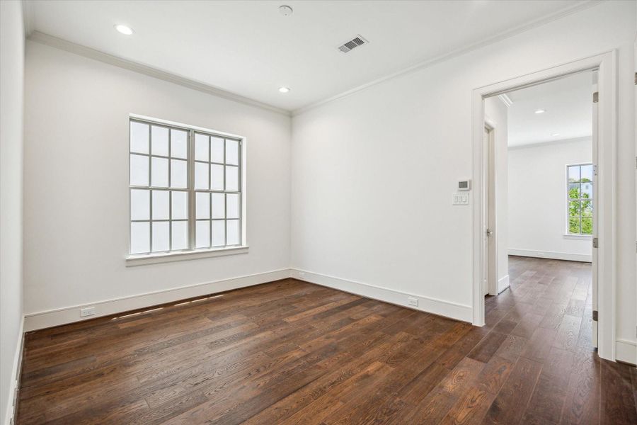 Sitting room off second floor stairwell landing, access to primary bedroom on right and utility room and secondary bedroom/bath on left.