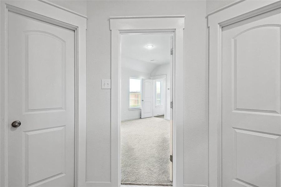 Hallway featuring carpet flooring