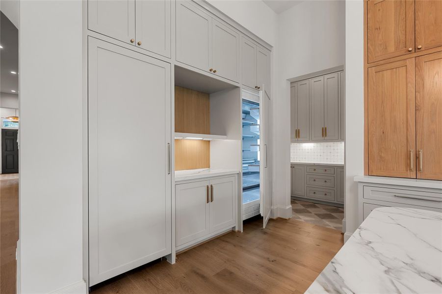 The refrigerator and freezer are hidden behind panels offering a clean look for your kitchen.