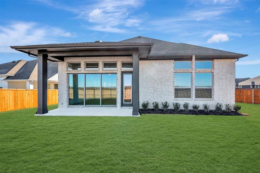 Rear view of property featuring brick siding and a patio Rear view of property featuring brick siding and a patio