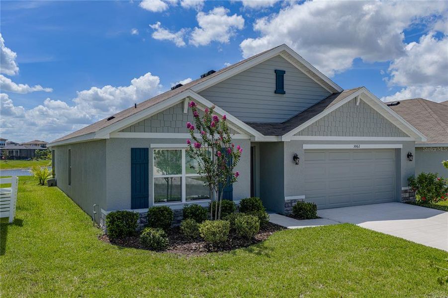 Front exterior of a new home in Berry Bay, Wimauma, FL, highlighting curb appeal (Image 27).