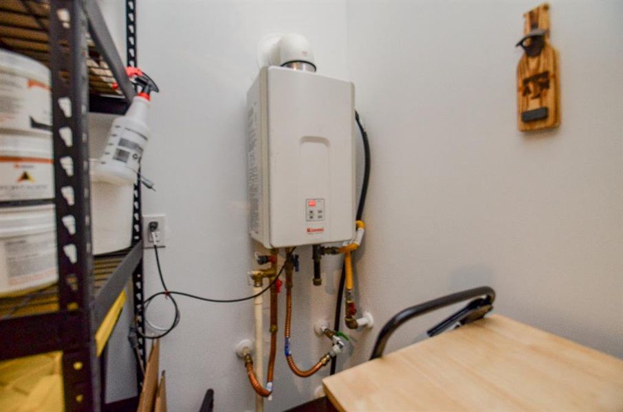 Garage has the gas tankless water heater, garage door opener, and sprinkler control panel.