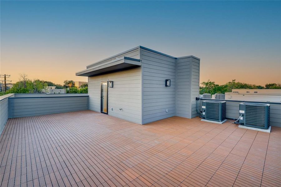 Patio terrace at dusk featuring cooling unit