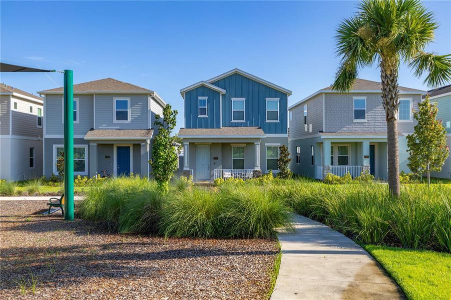 Front exterior of a new home in Serenade at Ovation, Winter Garden, FL, highlighting curb appeal (Image 22). Front exterior of a new home in Serenade at Ovation, Winter Garden, FL, highlighting curb appeal (Image 22).