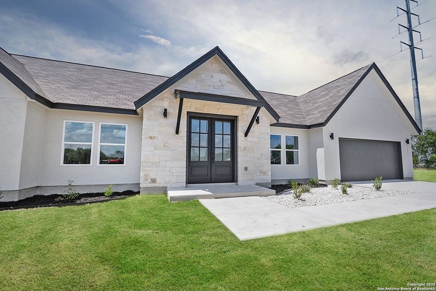 Front exterior of a new home in , Natalia, TX, highlighting curb appeal (Image 1).
