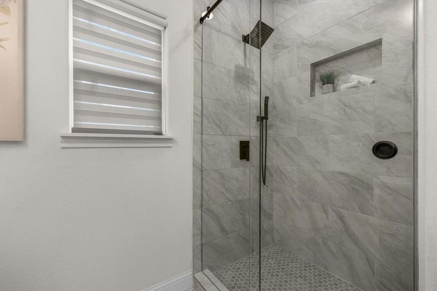 Bathroom featuring a shower with door