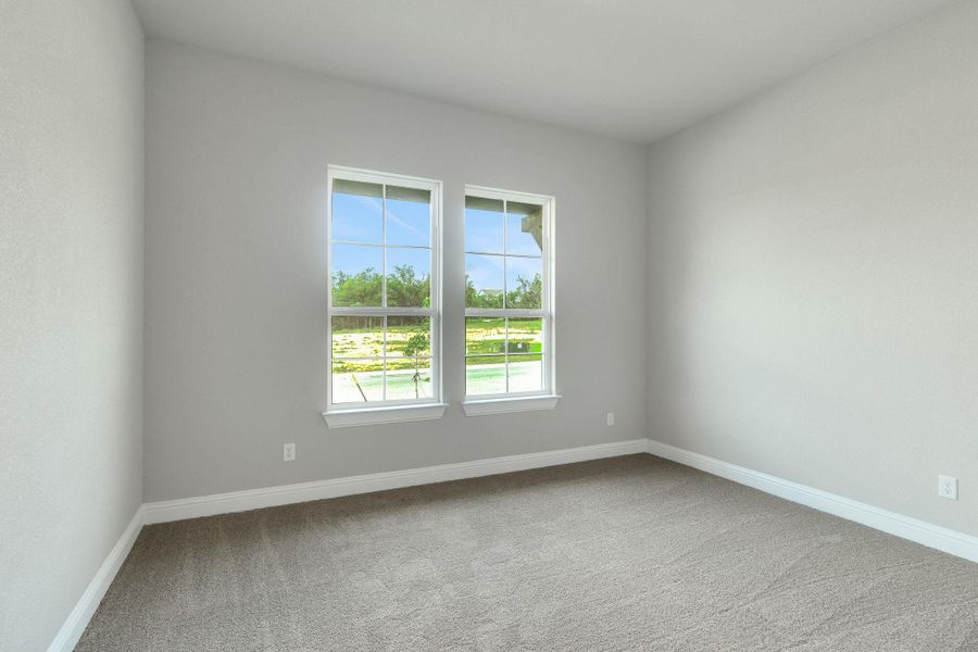 Empty room featuring baseboards and carpet