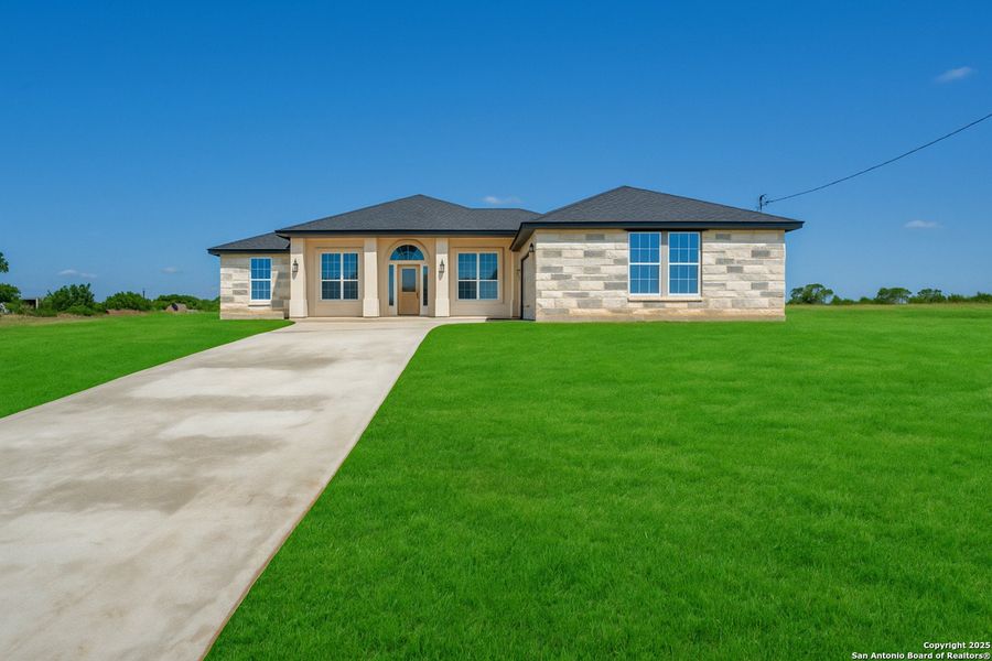 Front exterior of a new home in , Floresville, TX, highlighting curb appeal (Image 23).