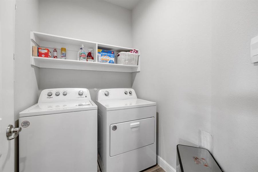 Laundry area with independent washer and dryer and baseboards