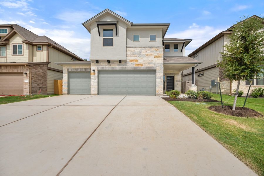 Front exterior of a new home in The Hills of Bear Creek, Manchaca, TX, highlighting curb appeal (Image 4).