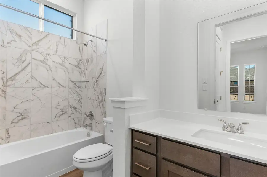 Full bathroom with washtub / shower combination and vanity