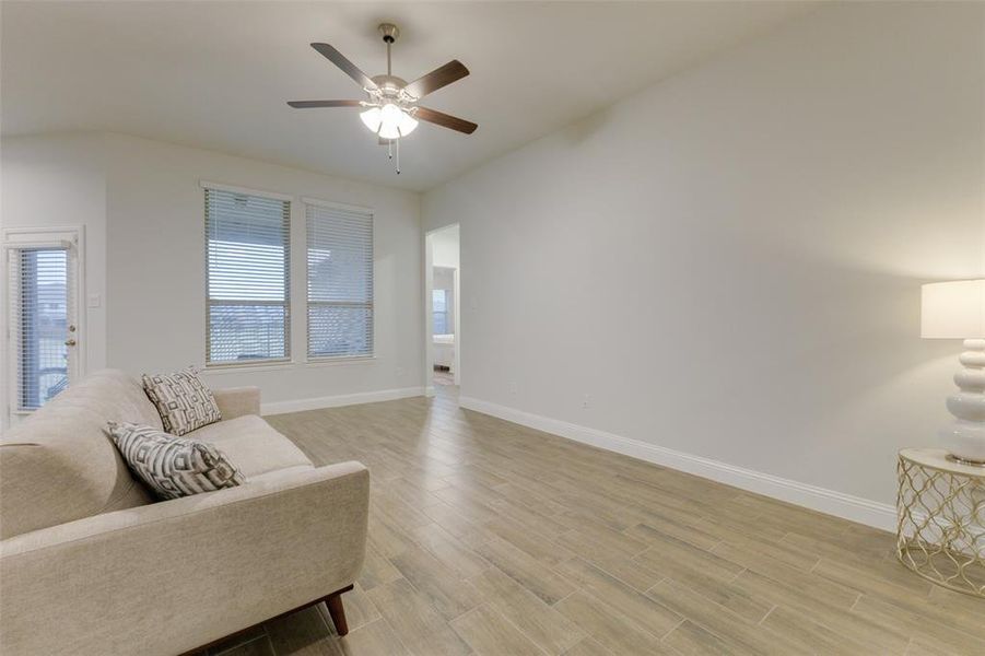 Living area featuring ceiling fan and light wood-type flooring